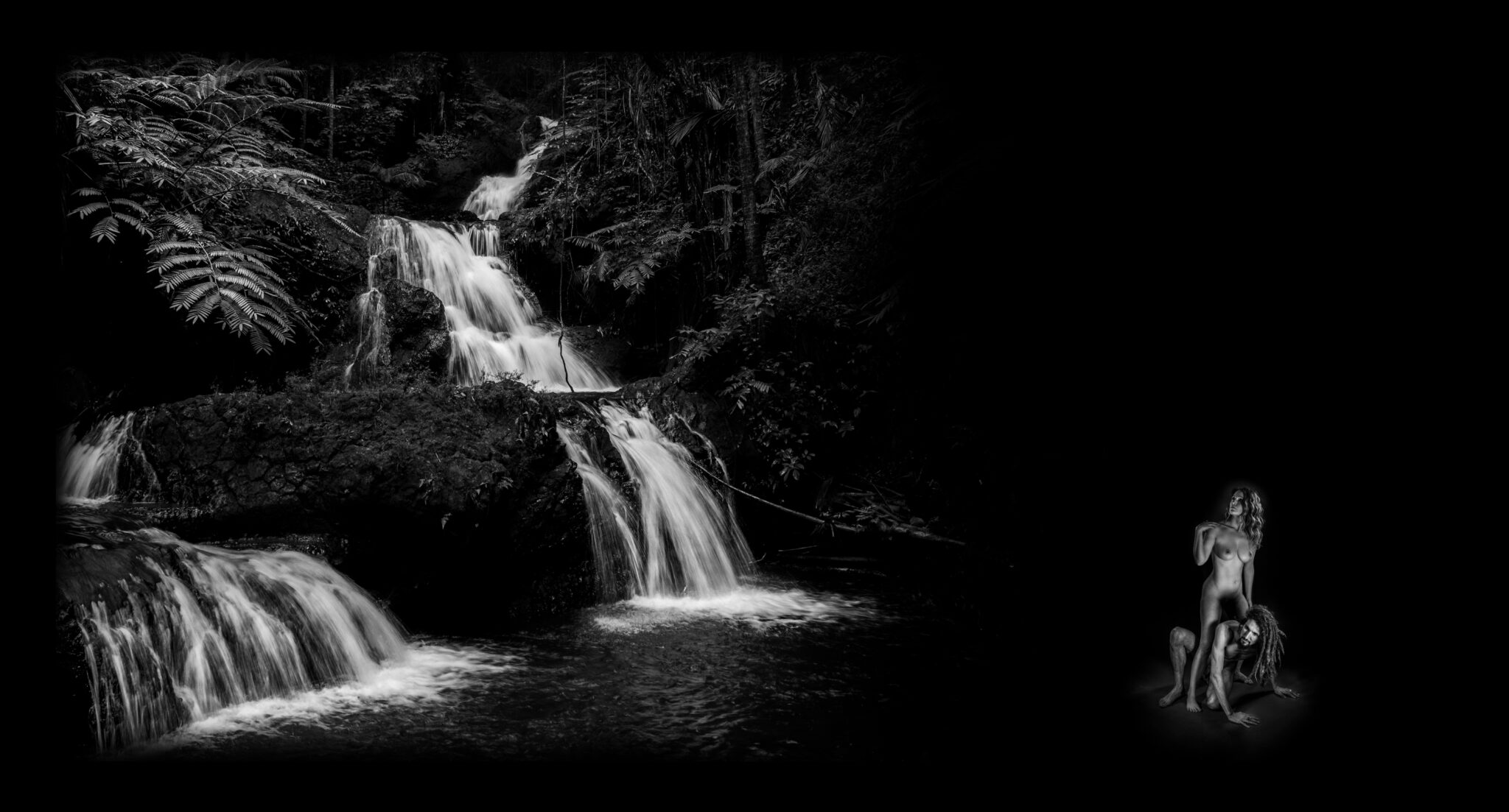 Black and white photograph of a nude couple against a backdrop of a waterfall that is depicting the story of Pontus being born from Gaia.