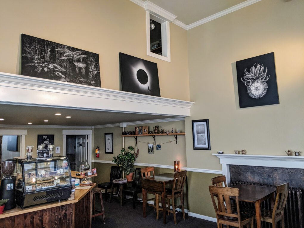 Photo of Cedar Coffee interior with artwork by Ira Gardner on the wall.