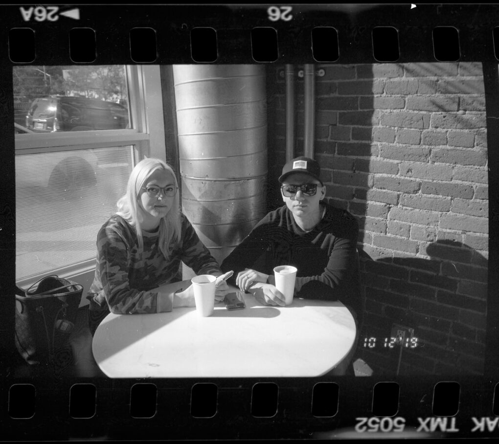 Photo of a young couple in a coffee shop.