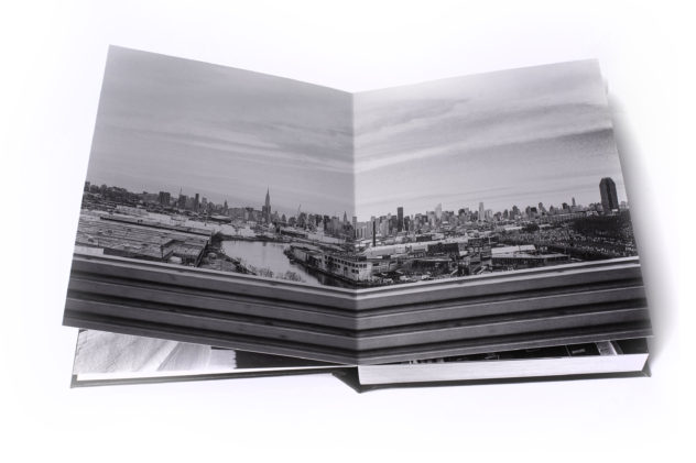 Image of a two page full bleed image of the New York skyline that is bound in a leather book.