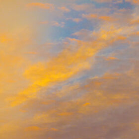 Abstract image of yellow clouds against blue sky
