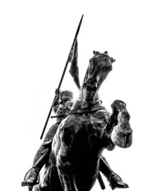 Photograph of a bronze sculpture from below the hoof of a horse.